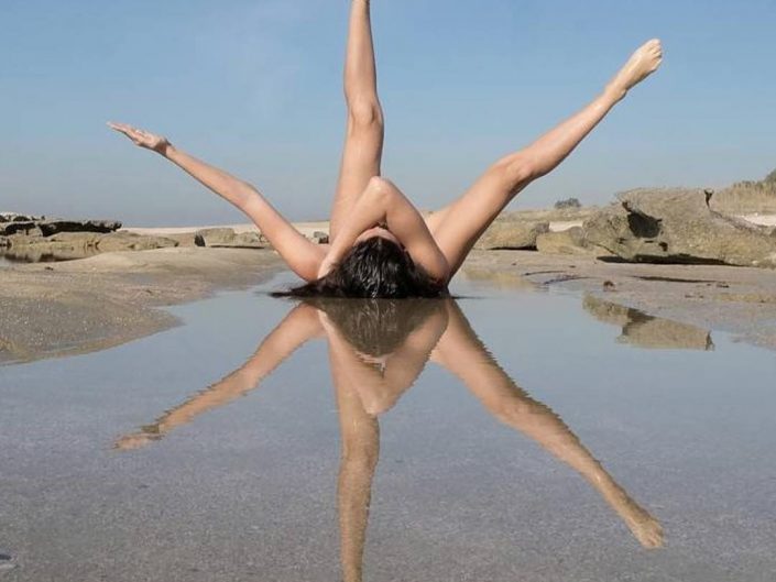 Jad Ghorayeb photo of a girl lying on secluded water, so her liften arm and two legs form a hexagon form with a mirror horizontal reflection